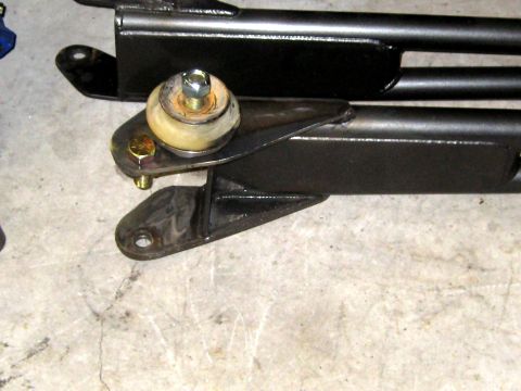 1996 Ford Bronco - A close-up view of a vehicle's suspension part, showing metal brackets and a rubber bushing.