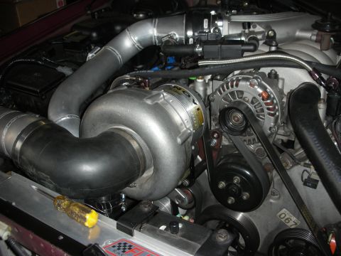 1992 Ford Crown Victoria - Engine bay detail showing a turbocharger and associated plumbing, likely a performance modification.