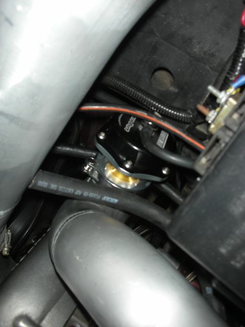 1992 Ford Crown Victoria - Close-up view of a black blow-off valve with a gold diaphragm, part of an intercooler project.
