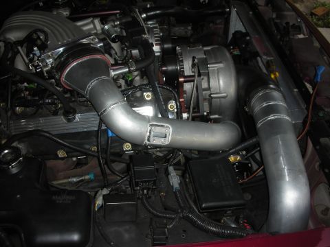 1992 Ford Crown Victoria - Custom intercooler piping and supercharger installed in an engine bay.