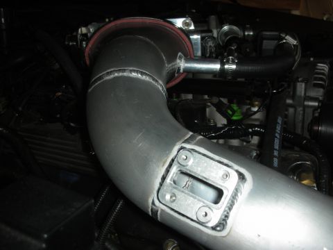 1992 Ford Crown Victoria - Close-up view of custom intercooler piping and engine components in a vehicle's engine bay.