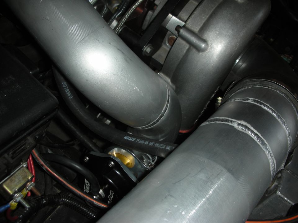 Close-up of turbocharger and intercooler piping with a blow-off valve