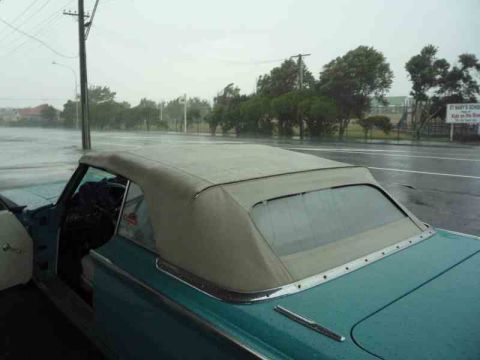 1969 Lincoln Continental - A 1969 Lincoln Continental convertible sits on a flooded road during a heavy rainstorm.