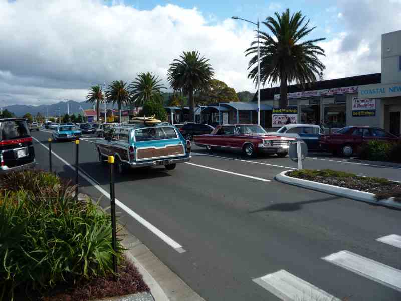 1969 Lincoln Continental and other classic cars parked on a street with palm trees