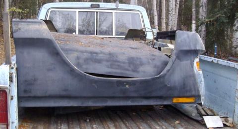 1979 Ford Bronco - A vehicle's rear fender and bed section is transported in the bed of a pickup truck.