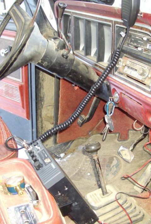 1978 Ford Bronco - The interior of an older vehicle is shown, a CB radio and keys in the ignition.