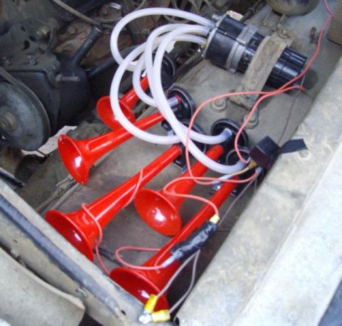 1978 Ford Bronco - Aftermarket air horns are installed in the engine bay, connected to a compressor and tubing.