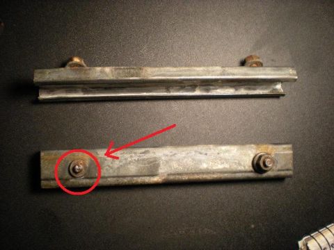 1993 Ford Bronco - Two metal tailgate brackets are shown, with a red circle highlighting a bolt on the lower bracket.