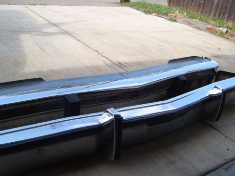 1973 Ford Ranchero - A chrome bumper with black trim and rubber guards is shown, likely a replacement part.