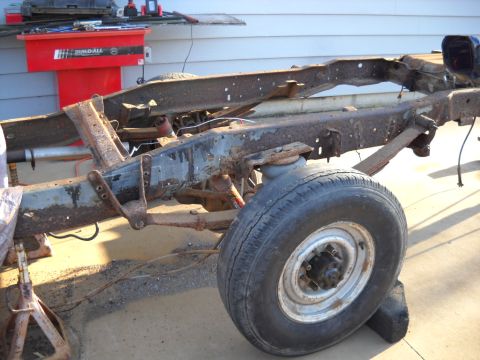 1954 Ford F-100 - The chassis and suspension components of a truck are visible, with a focus on the wheel and frame.