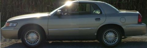 2000 Mercury Grand Marquis - This 2000 Mercury Grand Marquis sedan is seen from the side in a sunlit outdoor setting.
