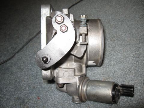1994 Ford Bronco - Close-up view of a throttle body assembly, likely for an older vehicle's engine.