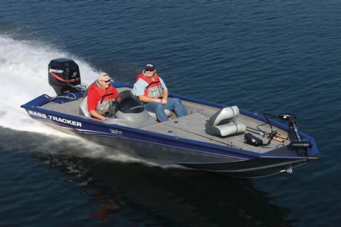 1998 Chevrolet Silverado 1500 - A Bass Tracker boat with two occupants cruises across the water, powered by a Mercury outboard motor.