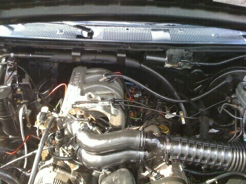1996 Ford Bronco - Engine bay view of a 1996 Ford Bronco, showing the V8 engine and air intake system.