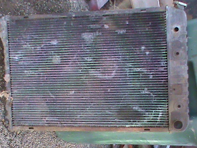 Old car radiator with damaged fins and corroded metal tanks