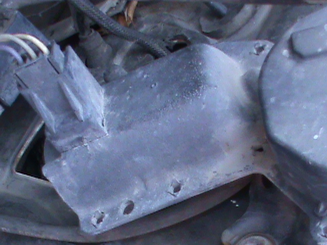 Gray engine part with electrical connector and wires
