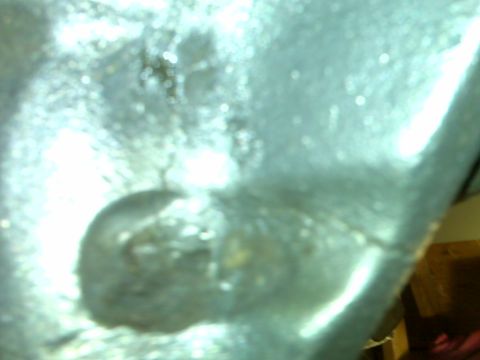 1983 Ford Bronco - This image shows a close-up of a metal component, likely part of a vehicle's frame.