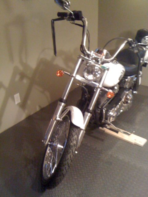 1984 Ford Bronco - Motorcycle front view with chrome handlebars and white fender. Album claims 1984 Ford Bronco.