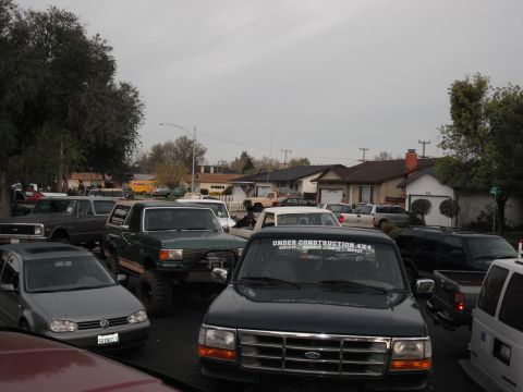1991 Ford Bronco - A dark green Ford pickup truck is parked in a residential area, with a sticker on the windshield reading "UNDER CONSTRUCTION 4X4".