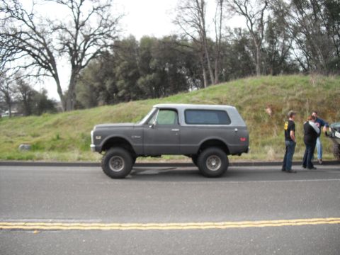 1991 Ford Bronco - A lifted 1972 K5 Blazer is parked on the side of a road with people standing nearby.