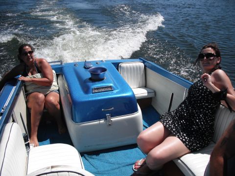 1991 Ford Bronco - Two women enjoy a boat ride on a sunny day, leaving a wake behind them.