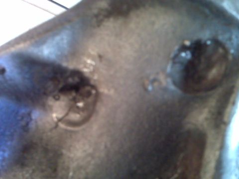 1983 Ford Bronco - Close-up view of a metal axle housing, showing bolts and a circular opening. The registry information may be inaccurate.