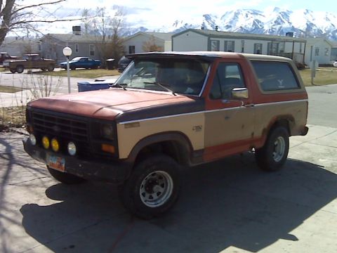 1983 Ford Bronco - Ford Bronco with a two-tone paint scheme and aftermarket lights is parked outdoors.