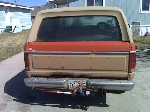 1983 Ford Bronco - This Ford Bronco has a two-tone paint scheme with a tan body and an orange stripe above the tailgate.