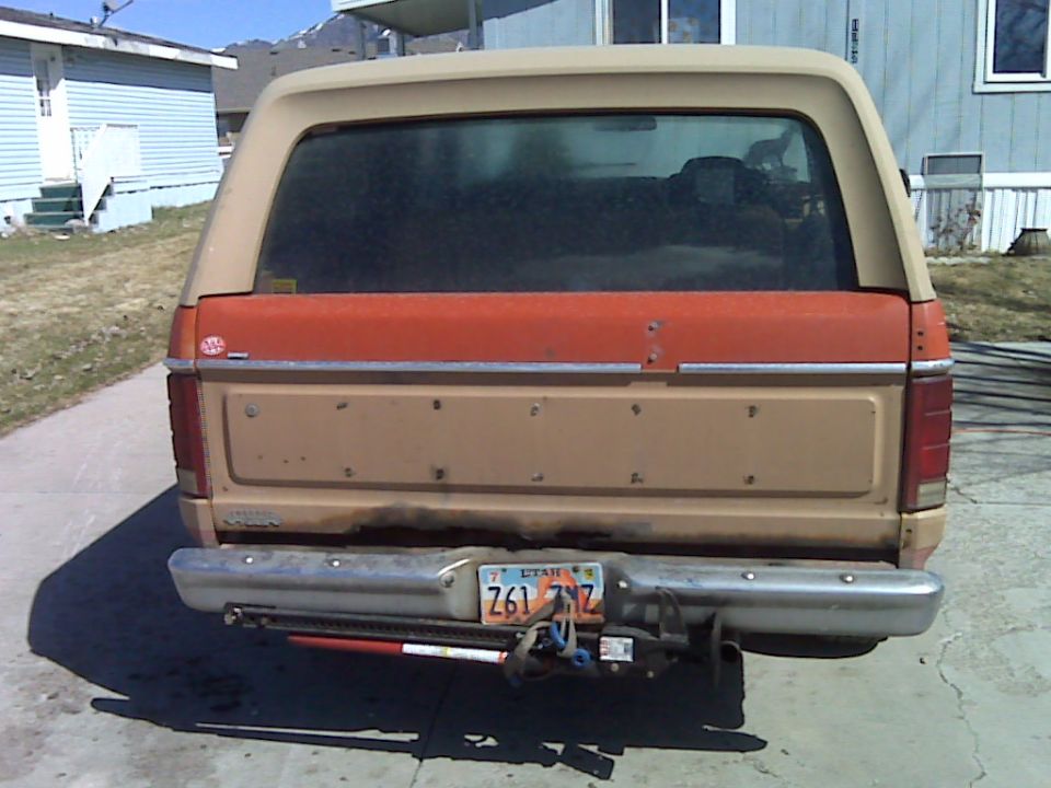 Rear view of a tan and orange Ford Bronco with a Utah license plate Z61 7NZ