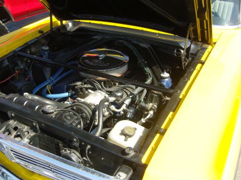 2007 Ford Mustang - Engine bay of a yellow car, showing the V8 engine and various components.
