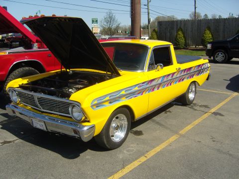 2007 Ford Mustang - This vintage pickup truck features custom flame decals and its hood is raised, revealing the engine compartment.