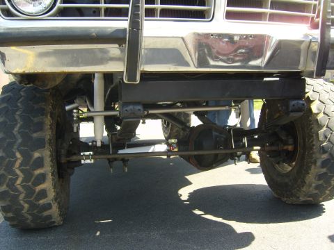 2007 Ford Mustang - Close-up view of the front suspension and differential on a modified truck.