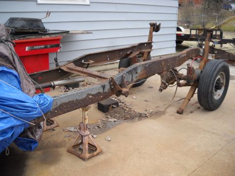 1954 Ford F-100 - The chassis of a 1953 Ford F-100 truck is shown, supported by jack stands.