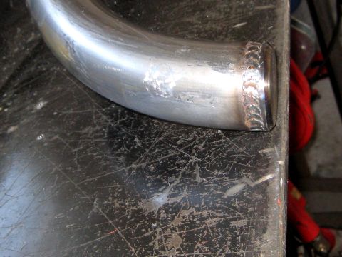 1996 Ford Bronco - A close-up of a metal pipe, showing weld marks and surface imperfections.