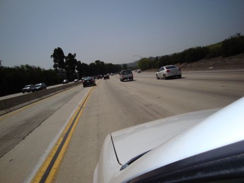 1995 Ford Taurus - Driving on a sunny day on a multi-lane highway with several other cars on the road.