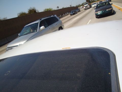 1995 Ford Taurus - A green 1995 Ford Taurus sedan is seen on the highway.