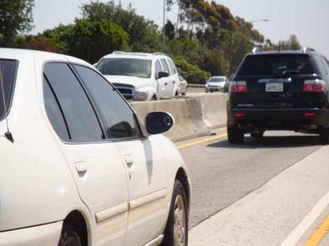 1995 Ford Taurus - Multiple vehicles are seen on a highway during daytime traffic.