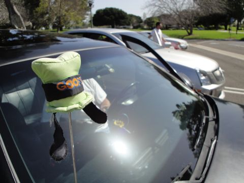1995 Ford Taurus - Goofy hat decoration on dashboard with another car in the background.