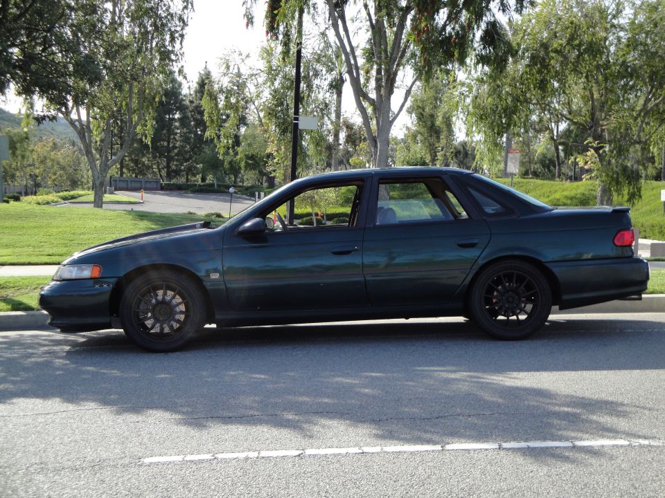 Side view of a 1995 Ford Taurus parked on a street