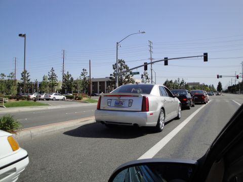 1995 Ford Taurus - A silver Cadillac sedan is seen in traffic on a sunny day, with other cars in front and behind it.