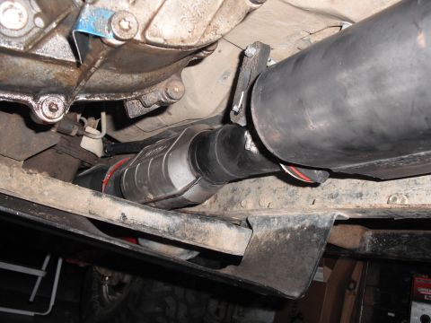 1991 Ford Bronco - The catalytic converter and exhaust pipe are visible from underneath the vehicle.