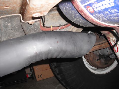 1991 Ford Bronco - Undercarriage view with exhaust pipe and air tank visible. The air tank is labeled Campbell Hausfeld.