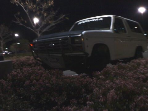 1986 Ford Bronco - This Ford Bronco is parked at night, a brush guard and a BFGoodrich sticker on the windshield.
