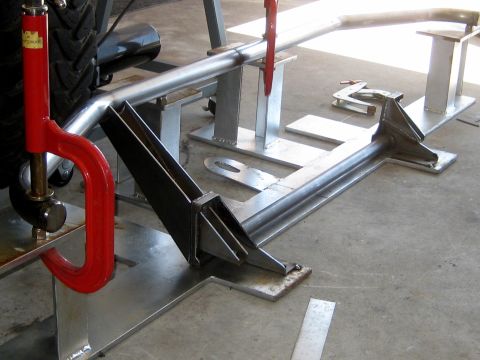1996 Ford Bronco - Metal tubing is being held by a C-clamp during fabrication work.
