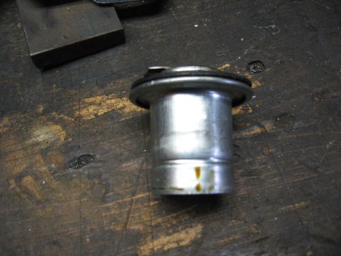 1994 Ford Bronco - Close-up of an unidentified metal automotive part with a rubber seal.