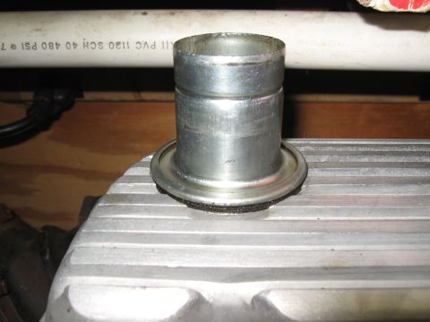 1994 Ford Bronco - Close-up of a metal fitting attached to an engine part, with a white pipe in the background.