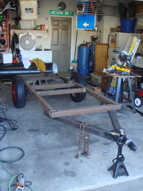 1992 Ford Bronco - Unfinished trailer frame sits in a garage, awaiting completion.