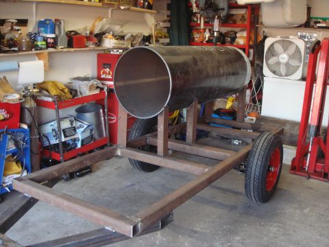 1992 Ford Bronco - A large metal cylinder is mounted on a custom trailer frame, likely for a smoker build, inside a workshop.