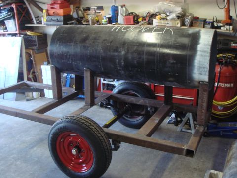 1992 Ford Bronco - A custom trailer carries a large black cylinder, possibly for a smoker, in a workshop setting.