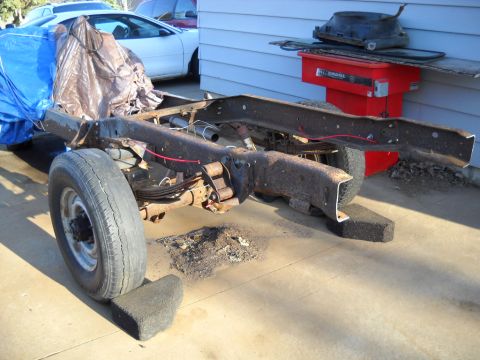 1954 Ford F-100 - The bare frame of a truck sits on blocks, awaiting restoration or repair.
